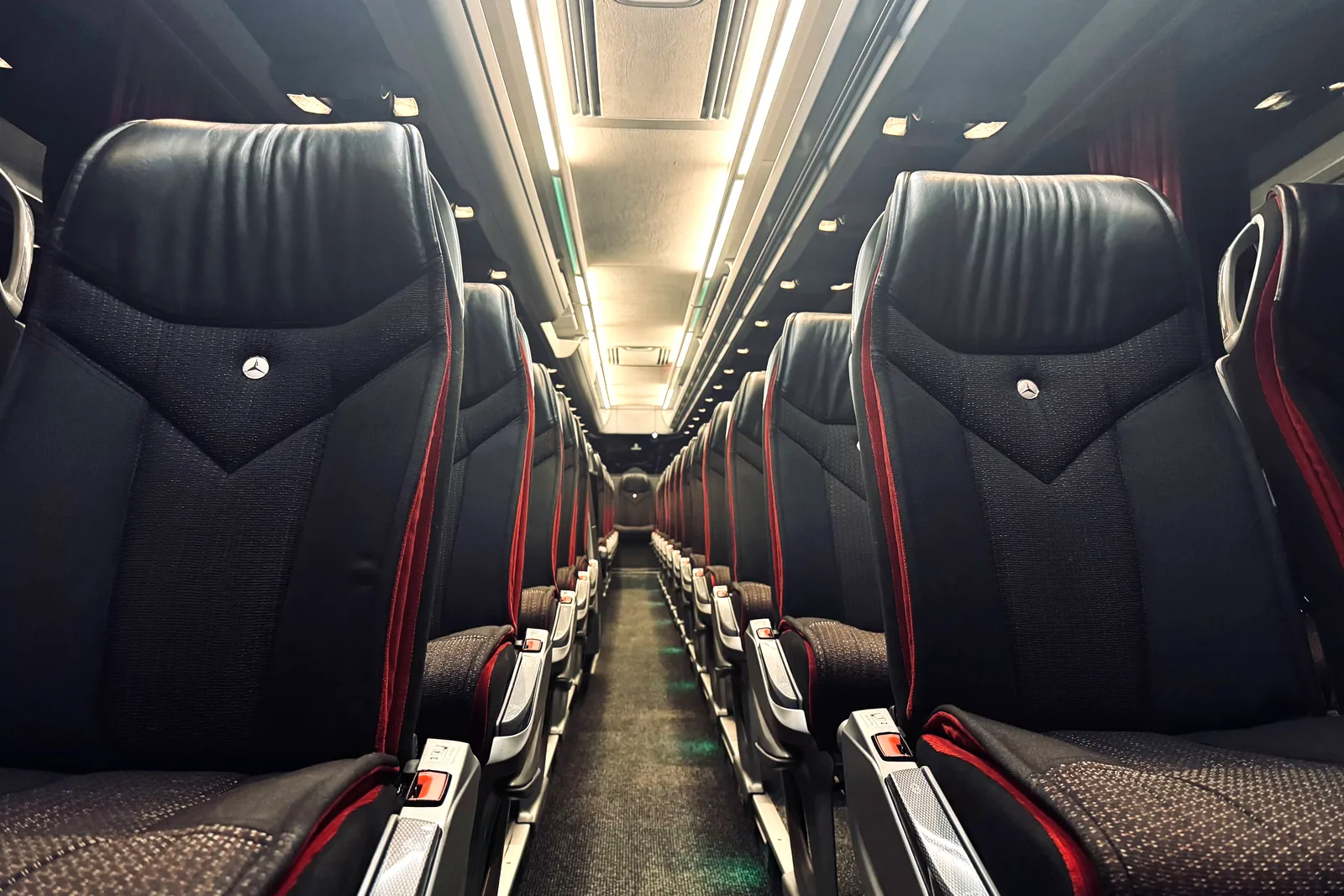 Black leather seats with red stitching on board the Travego coach